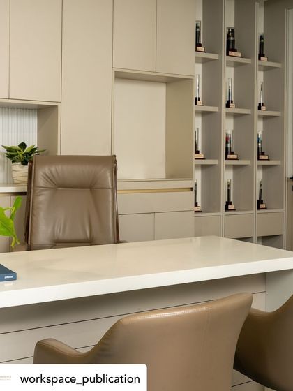 A detailed view of the MD's cabin, focusing on the custom cabinetry and the elegant, high-back leather chair that provides ergonomic support.