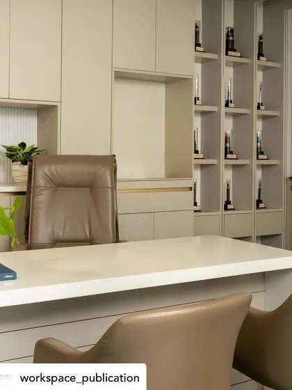 A detailed view of the MD's cabin, focusing on the custom cabinetry and the elegant, high-back leather chair that provides ergonomic support.