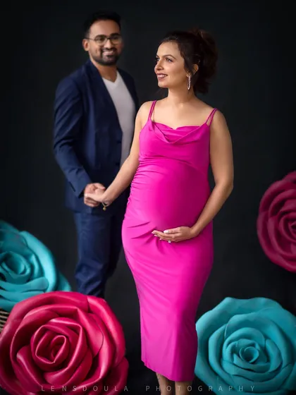 A beautiful portrait capturing the couple's shared glance, with the mother-to-be looking radiant and confident.