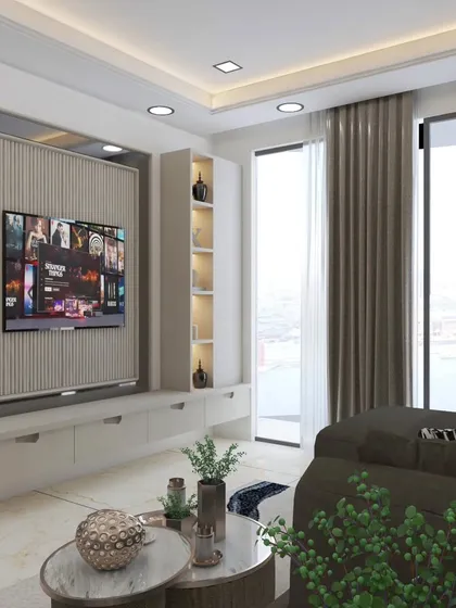 A sleek, floating TV unit with vertical fluting and integrated shelving provides ample storage while maintaining a light, modern aesthetic. The large windows allow for plenty of natural light.