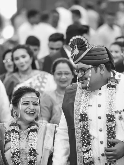 A genuine, unposed moment of laughter between the bride and groom during their wedding ceremony. We believe these candid black and white shots capture the true joy of the day.