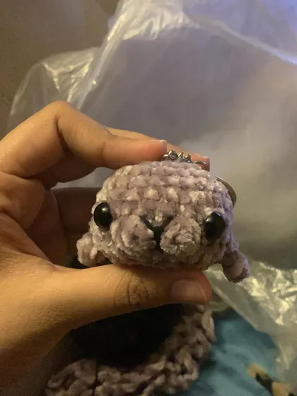 A close-up of a seal keychain made with soft, mauve-colored velvet yarn. The pattern for this lil' guy will be coming soon!