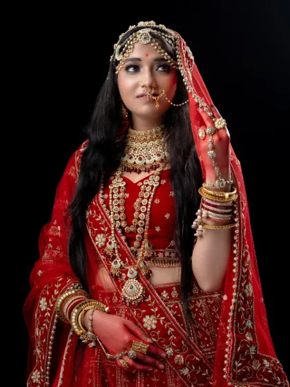 A close-up of the Padmavathi look, showcasing the intricate jewelry, makeup, and delicate veil. I ensure every detail is perfect for your historical-themed shoot.