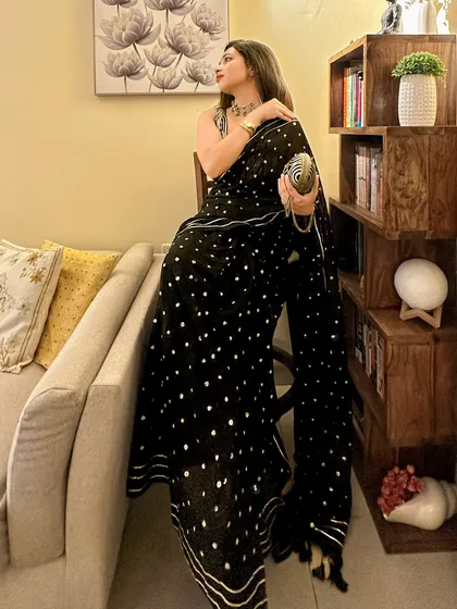A wedding guest look that proves comfort can be glamorous. This is a mul cotton saree with sequin work and a gota patti border, which gives it a festive feel without compromising on comfort. Perfect for a friend's or colleague's wedding.