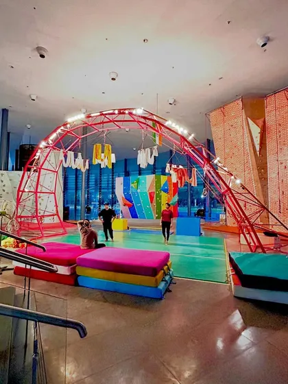 An evening view of our studio, lit up and ready for action. The colorful crash pads and structures create an energetic and inviting atmosphere.