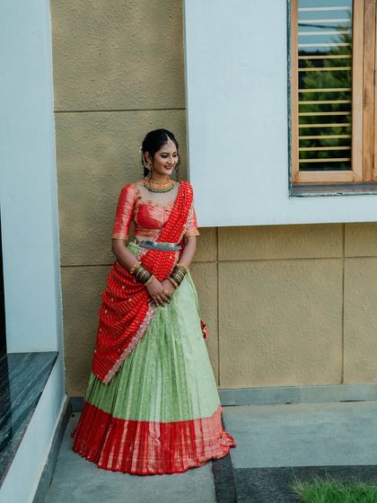 My beautiful client Chethana looks stunning in this custom Kanchi Pattu tissue lehenga. The sea-green and red combination is a classic, and I designed it as a Langa Voni for a traditional yet fresh look for her special day.