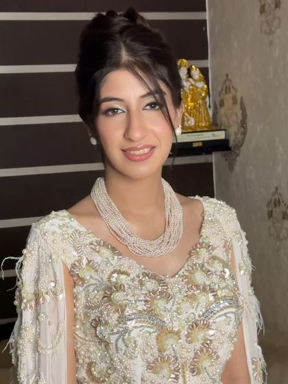 A beautiful smile from this stunner. The high bun and soft makeup create a look of effortless sophistication.