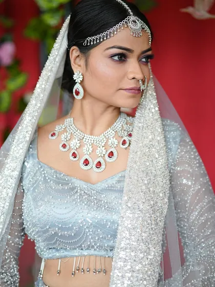 Another close up of this beautiful modern bride. The focus is on the stunning diamond and ruby necklace set and how the makeup complements the cool tones of the jewelry and outfit.