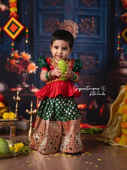 Celebrating tradition is at the heart of what I do. This portrait captures a little one dressed in a beautiful Pattu Langa for a traditional ceremony shoot. The backdrop is rich with cultural elements like marigolds and mango leaves, creating a vibrant and authentic festive atmosphere.