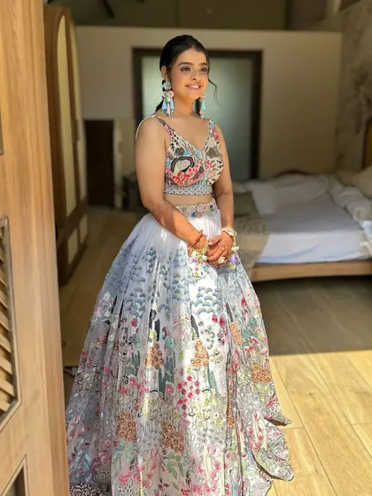 A dreamy engagement look for Jenice. Her makeup is soft and romantic, with a touch of sparkle on the eyes, perfectly matching her beautiful floral lehenga.
