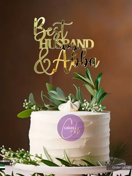A mockup showing a "Best Husband & Abba" topper on a simple white cake, a heartfelt message for a special family man.