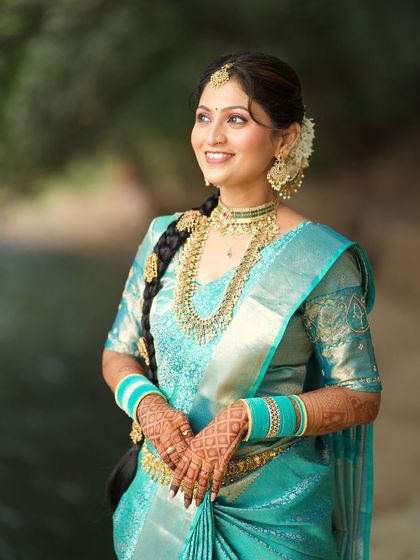 A happy and radiant portrait of the bride. Her smile and glowing skin are the highlights of this beautiful South Indian look.