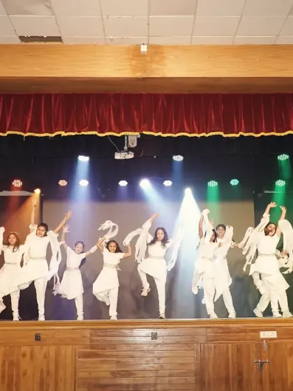 A wide shot of the junior contemporary dance, showcasing the beautiful formations and use of the entire stage.