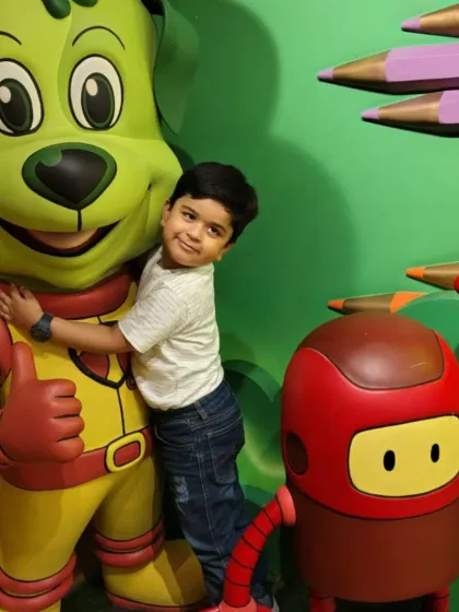A young boy gives our mascot Tinga Dojo a big, friendly hug.