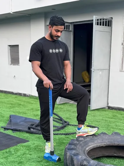 Every day is another chance to get stronger. A shot of me with a sledgehammer and tire, a classic tool for building raw power.