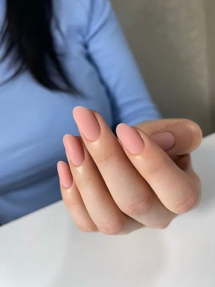 A beautiful matte manicure in a soft, dusty rose color. The matte finish gives these elegant almond-shaped nails a modern and sophisticated touch.