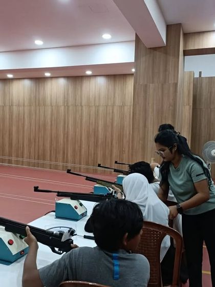 Safety and proper technique are the first things we teach. Here, one of our certified coaches is instructing a group of new shooters, ensuring everyone understands the fundamentals before they take their first shot.