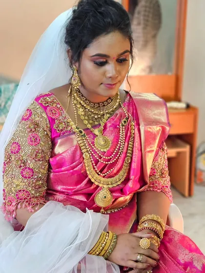 A full view of the bride who wore a pink Kanjivaram saree with a white veil for her Christian wedding. A beautiful blend of cultures.