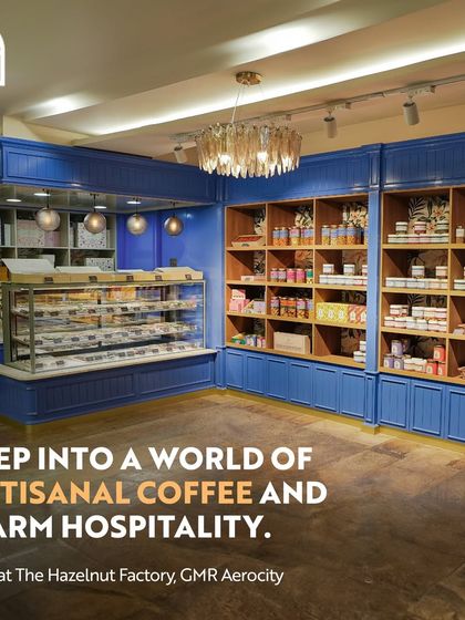 Step into a world of artisanal coffee and warm hospitality at The Hazelnut Factory. The image shows a beautiful patisserie counter filled with tempting treats and a welcoming ambiance.