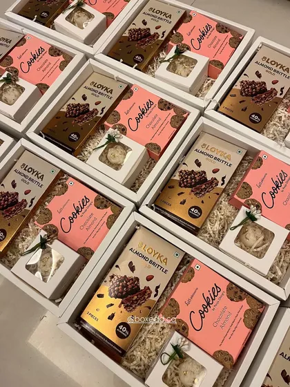 Great gifts don't always need a huge budget. This image showcases our budget-friendly Diwali hampers filled with delicious cookies and almond brittle, proving that thoughtful gifting can be accessible.