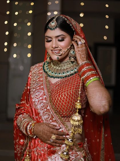 Adjusting the final details. I fuss over every little thing, from the kalire to the nath, so that my bride feels completely comfortable and looks perfect from every angle.