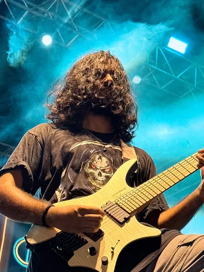 Our guitarist lost in the music, headbanging during a heavy riff. This is the raw rock energy we bring.