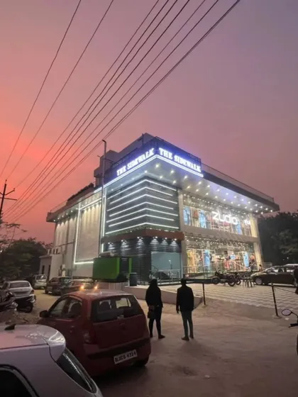 Here is the completed 'The Sidewalk' commercial building in Rajnagar at dusk. The facade lighting I designed creates a striking presence, highlighting the modern architecture and making it a landmark in the area.