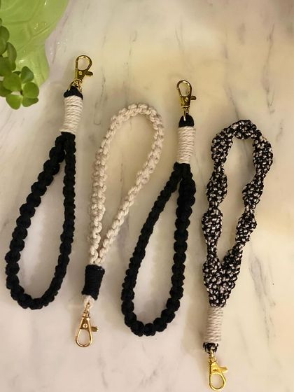 Here are some of my wristlet keychains in classic black, off-white, and a fun black-and-white pattern. These neutral options go with everything.