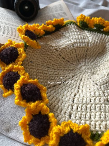 A detailed shot of the sunflower border on our crochet table mat. Each tiny sunflower is stitched by hand, making this a truly special piece.