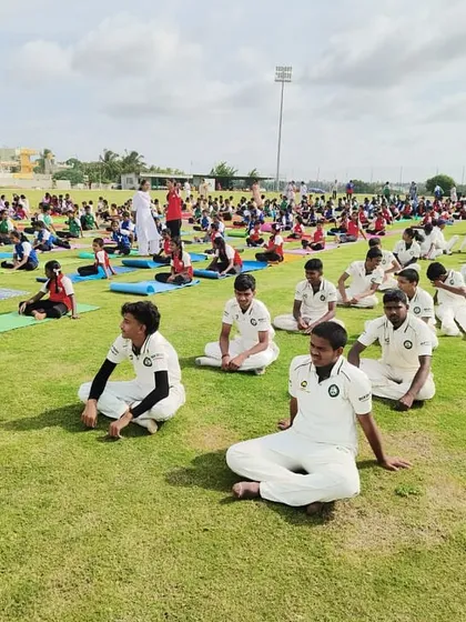 Mental and physical conditioning are key. Here, our students participate in a large-scale yoga session on the field, a core part of our holistic approach to player development.