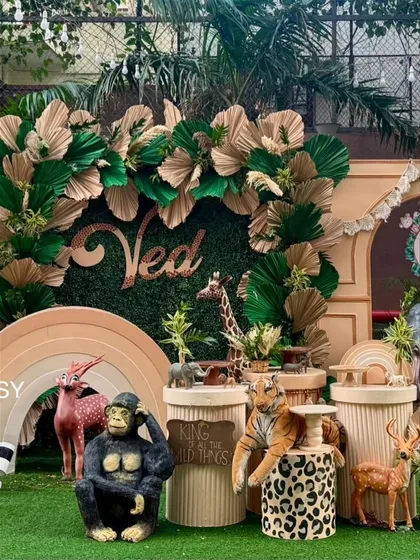 A close-up of the animal props, including a gorilla, tiger, and deer, arranged around a 'King of all the Wild Things' sign.