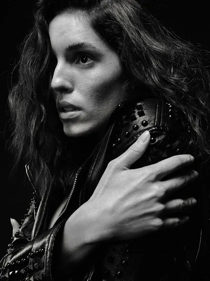 A profile view from the same edgy series, with the light catching the details of the leather jacket and sculpting the model's features.