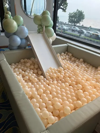 A beautiful sage green ball pit with a slide, overlooking the sea, provided endless fun for the little ones at Noah's party.