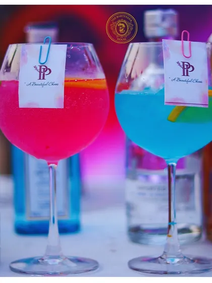 Our "A Beautiful Chaos" cocktails, one pink and one blue, are designed to be as visually striking as they are delicious.