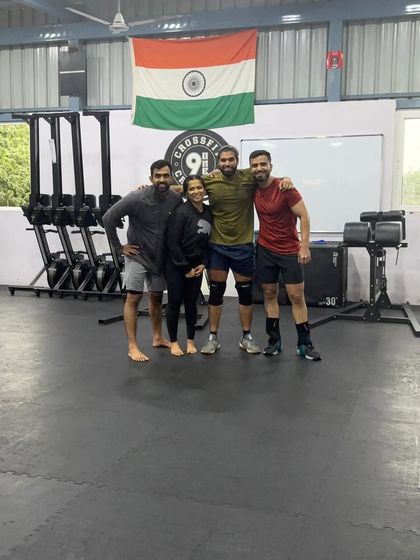 A smaller group photo under the Indian flag at our box. We are proud of our community and the strength we build together.