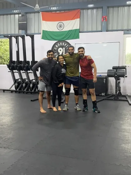 A smaller group photo under the Indian flag at our box. We are proud of our community and the strength we build together.