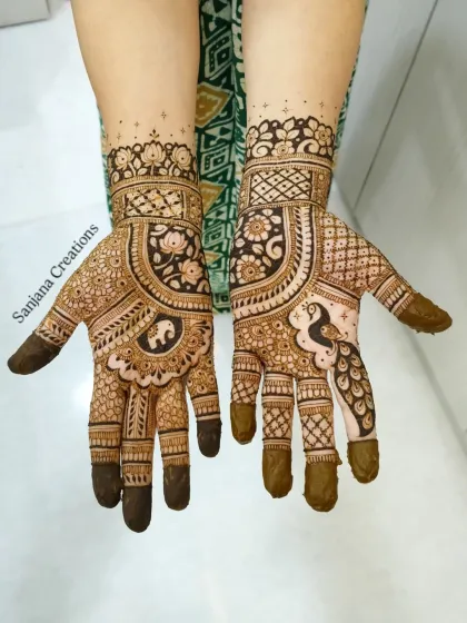 A beautiful bridal design featuring an elephant on one hand and a peacock on the other, symbolizing wisdom and beauty.