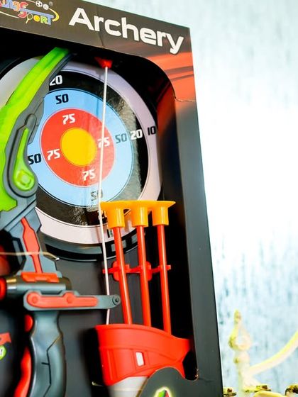 A safe archery game booth with suction-cup arrows and a target, perfect for aspiring archers.