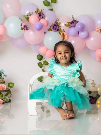 A radiant smile from the two-year-old birthday girl. Her happiness lights up the entire studio during this fun milestone session.