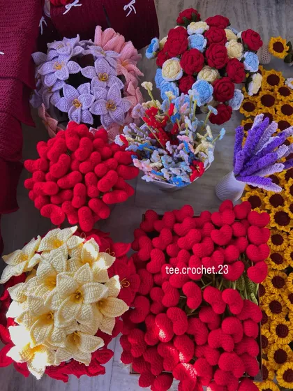 An overhead shot of various flower types ready for packing, including lilies, hearts, and forget-me-nots.