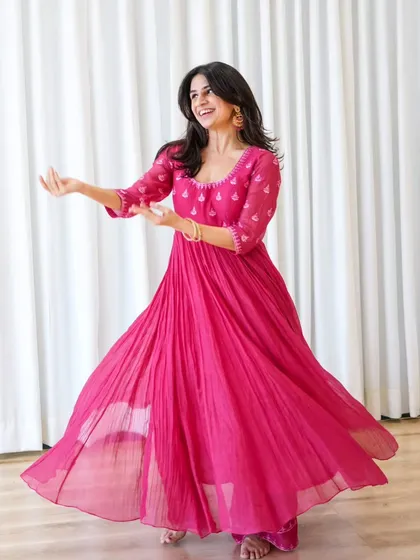 A dynamic shot from a professional shoot, showcasing the beautiful flare of the anarkali during a dance move. This highlights the visual appeal of our semi-classical routines.