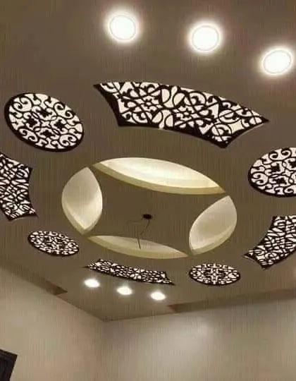 This ceiling uses floating jali panels to create a stunning decorative effect. The light shines through the intricate patterns, casting beautiful shadows and adding a layer of artistry to the room.