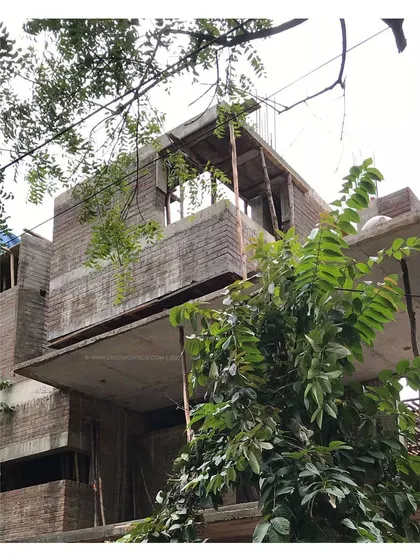An earlier construction photo of 'Residence 97.' This image reveals the building's structural bones, with exposed brickwork and concrete slabs, before the final facade materials were applied.