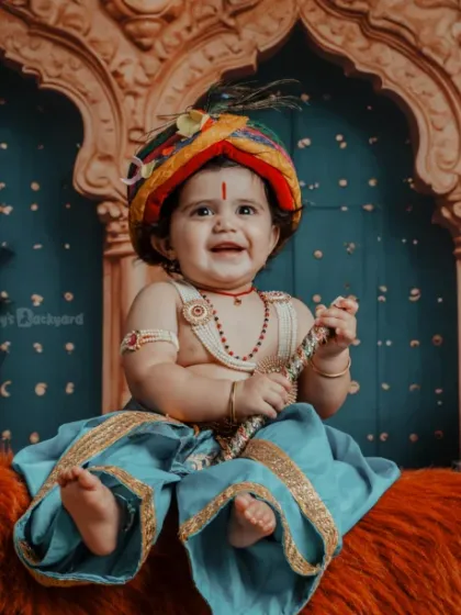 Flute in hand, innocence in eyes. Here’s our mini Krishna spreading joy in a grand, traditional setting.