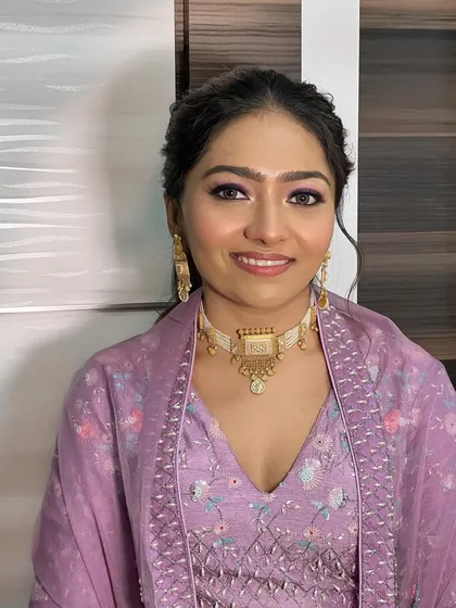 A smiling shot of this client, her lavender makeup looking fresh and beautiful.