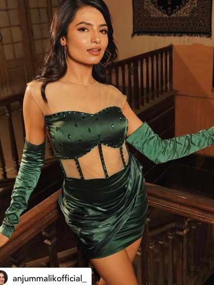A full-length view of the custom green satin dress I designed for the song 'Koka'. The draping and corset detailing were carefully crafted to create a striking silhouette.