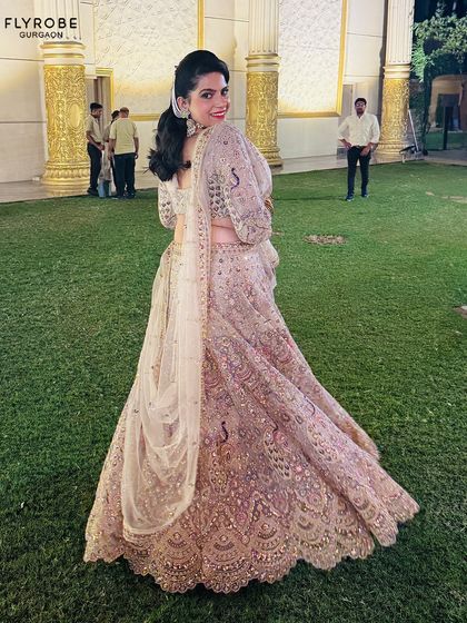 This stunning sequined lehenga proves you don’t have to buy to shine. A happy client twirls in this glamorous outfit, perfect for a sangeet or cocktail night.