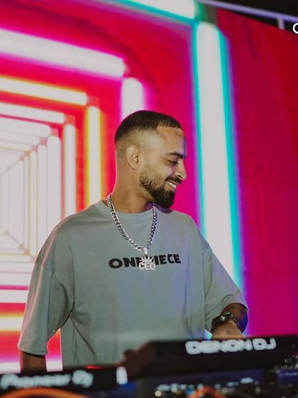 A DJ smiles as he looks out at the crowd. The connection between the artist and the audience is essential for creating an unforgettable night.