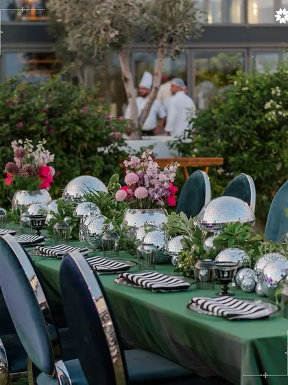 A welcome dinner in Turkey featuring a modern, playful tablescape with disco balls and fresh florals. This shows our ability to blend sophisticated design with a fun, celebratory spirit.