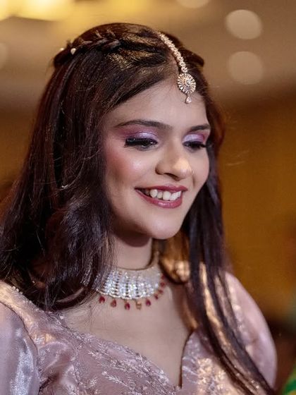 A sweet, smiling candid of the bride during one of the pre-wedding functions. The soft lighting captures her happiness perfectly.